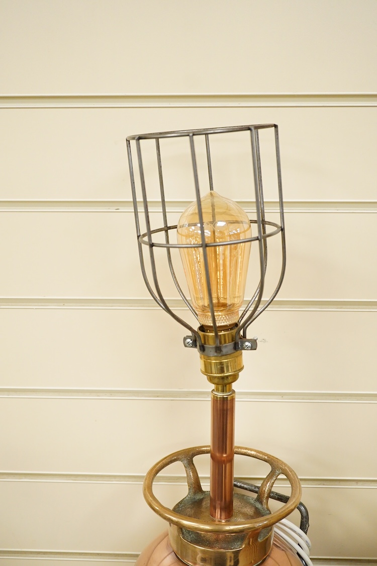 A copper fire extinguisher mounted as a table lamp, overall 93cm high